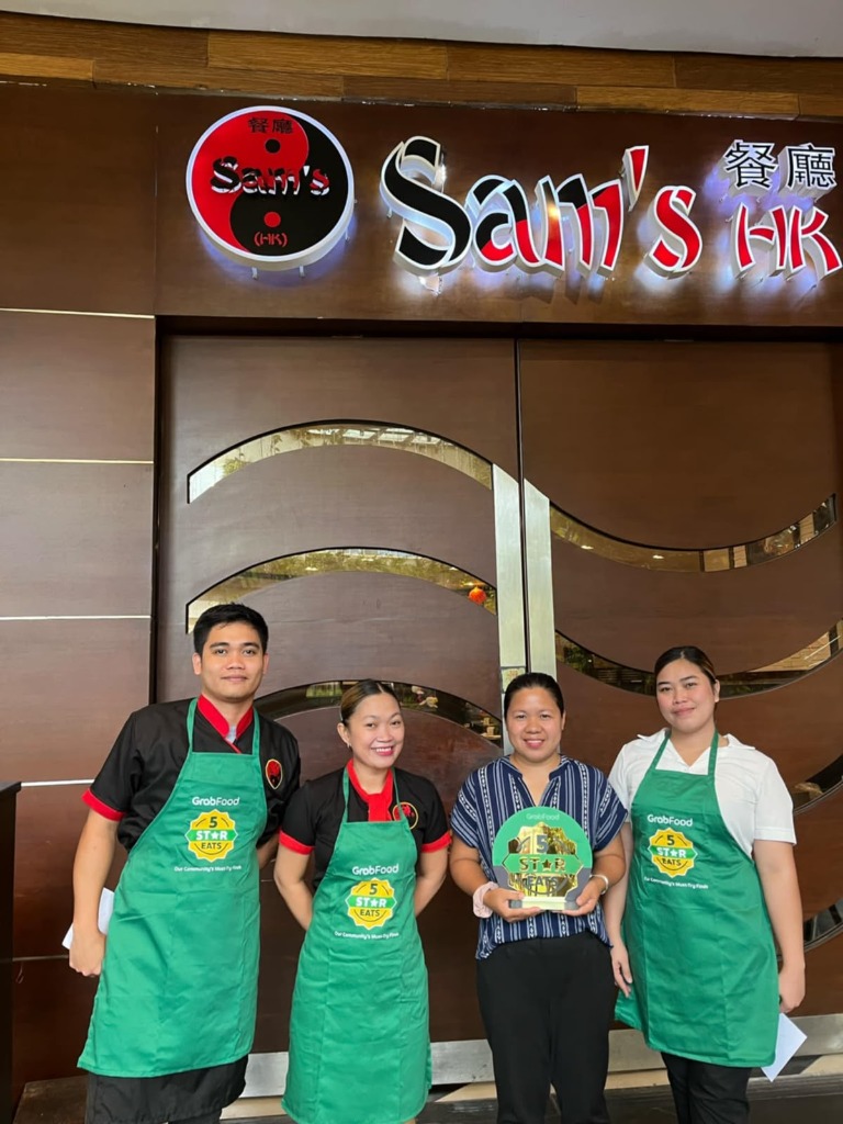 Sam's HK Team holding GrabFood 5-Star Eats Award